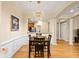 Bright dining room with modern chandelier, hardwood floors, and view of the kitchen at 560 Dutch Valley Ne Rd # 209, Atlanta, GA 30324