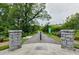 Stone pillar entrance to a paved park path surrounded by lush greenery and leading to Midtown Atlanta at 560 Dutch Valley Ne Rd # 209, Atlanta, GA 30324