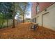Bench seating surrounded by mature trees, mulch, and an iron fence on the building grounds at 560 Dutch Valley Ne Rd # 209, Atlanta, GA 30324