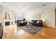 Sunlit living room with a fireplace, elegant rug, and comfortable sofas at 560 Dutch Valley Ne Rd # 209, Atlanta, GA 30324