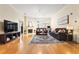 Bright living room with hardwood floors, a fireplace, and a large television at 560 Dutch Valley Ne Rd # 209, Atlanta, GA 30324