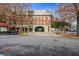 Multi-story upscale red brick building with underground parking entrance, surrounded by parking and mature trees at 560 Dutch Valley Ne Rd # 209, Atlanta, GA 30324