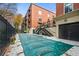Community pool with a cover for off-season use at a brick building with balconies at 560 Dutch Valley Ne Rd # 209, Atlanta, GA 30324