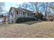 Side view of ranch home showcasing green shutters and a well-maintained lawn at 141 Hill St, Roswell, GA 30075