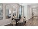 Modern dining room with hardwood floors and three arched mirrors at 2094 Moss Hill Road, Stone Mountain, GA 30088