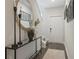 Bright entryway featuring wood flooring, modern decor, and a stylish console table with a round mirror at 2094 Moss Hill Road, Stone Mountain, GA 30088