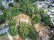 Aerial shot of the property and surrounding lush trees, set on an expansive private lot in a neighborhood at 72 Bishop Nw Dr, Cartersville, GA 30121