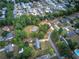 An aerial view depicts the home surrounded by trees in a suburban neighborhood with manicured lawns and mature trees at 72 Bishop Nw Dr, Cartersville, GA 30121
