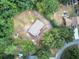 An overhead shot exhibits the home, surrounded by trees, and its curved driveway within a lush, private landscape at 72 Bishop Nw Dr, Cartersville, GA 30121