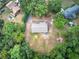 An aerial view of a home with a circular driveway surrounded by lush greenery and neighboring houses at 72 Bishop Nw Dr, Cartersville, GA 30121