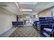 Finished basement space with blue chairs, paneled walls, and fluorescent lighting at 72 Bishop Nw Dr, Cartersville, GA 30121