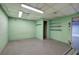 Unfinished basement space with concrete floors, green painted walls, and fluorescent lighting at 72 Bishop Nw Dr, Cartersville, GA 30121