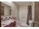 Bathroom featuring a shower-tub combo and a patterned tile surround at 72 Bishop Nw Dr, Cartersville, GA 30121