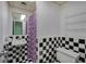 Retro bathroom with black and white checkered tile, sink, toilet, and purple shower curtain at 72 Bishop Nw Dr, Cartersville, GA 30121