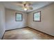 Bedroom with two windows, wood-look flooring and ceiling fan at 72 Bishop Nw Dr, Cartersville, GA 30121