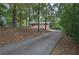 Long driveway leading to a brick home surrounded by mature trees and natural beauty at 72 Bishop Nw Dr, Cartersville, GA 30121