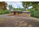 Brick home with a covered porch and seating, complemented by a driveway and trees at 72 Bishop Nw Dr, Cartersville, GA 30121