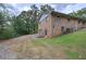 Brick two-story home with a convenient garage and a spacious driveway, surrounded by trees at 72 Bishop Nw Dr, Cartersville, GA 30121