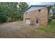 Brick two-story home with a convenient garage and a spacious driveway, surrounded by trees at 72 Bishop Nw Dr, Cartersville, GA 30121