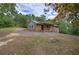 A brick home with a covered front porch surrounded by a grass yard and mature trees at 72 Bishop Nw Dr, Cartersville, GA 30121