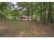 Brick ranch-style home with treed front yard and long driveway leading to the property at 72 Bishop Nw Dr, Cartersville, GA 30121