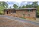 Charming brick home featuring a covered front porch with seating and mature landscaping at 72 Bishop Nw Dr, Cartersville, GA 30121