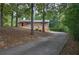 Brick home with an inviting front porch and a long driveway through a treed yard at 72 Bishop Nw Dr, Cartersville, GA 30121