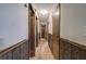 View of the hallway with wood-trimmed wainscotting and wood flooring at 72 Bishop Nw Dr, Cartersville, GA 30121
