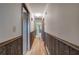 Long hallway with wood paneled walls, overhead lighting, and several doorways at 72 Bishop Nw Dr, Cartersville, GA 30121