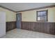 Traditional-style kitchen featuring wood paneling, tile flooring, and neutral wall paint at 72 Bishop Nw Dr, Cartersville, GA 30121