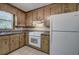 Traditional-style kitchen featuring wood cabinets, white appliances and granite countertops at 72 Bishop Nw Dr, Cartersville, GA 30121