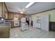 Traditional-style kitchen with wood cabinets, white appliances, tile flooring, and lots of storage at 72 Bishop Nw Dr, Cartersville, GA 30121