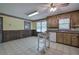Traditional-style kitchen with wood cabinets, granite countertops, tile flooring, and natural light at 72 Bishop Nw Dr, Cartersville, GA 30121