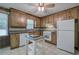 Traditional-style kitchen features wood cabinets, white appliances and tile flooring at 72 Bishop Nw Dr, Cartersville, GA 30121