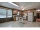 Traditional-style kitchen with wood cabinets, granite countertops, white appliances, and tile flooring at 72 Bishop Nw Dr, Cartersville, GA 30121