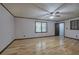 Light-filled living room with hardwood floors, a ceiling fan, and a view to front door at 72 Bishop Nw Dr, Cartersville, GA 30121