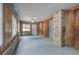 Enclosed sunroom with wood paneling, brick accents, concrete flooring, ceiling fan and natural light at 72 Bishop Nw Dr, Cartersville, GA 30121