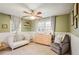 Bright Bedroom featuring a crib, dresser, and rocking chair at 1609 Deerwood Ln, Acworth, GA 30102