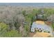 Aerial view of a home with a silver roof, a well-manicured yard, a pool, and tall trees for maximum privacy at 4540 Club Valley Ne Dr, Atlanta, GA 30319