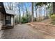 Brick patio and lush backyard with mature trees and a brick retaining wall at 4540 Club Valley Ne Dr, Atlanta, GA 30319
