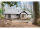 Exterior of home with brick patio and view of trees at 4540 Club Valley Ne Dr, Atlanta, GA 30319