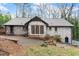 Rear exterior of home with brick patio and lush, wooded backyard at 4540 Club Valley Ne Dr, Atlanta, GA 30319