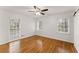 Clean bedroom with hardwood floors, light walls, ceiling fan and natural light from two large windows at 4540 Club Valley Ne Dr, Atlanta, GA 30319