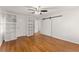 Spacious bedroom with hardwood floors, built-in shelving, ceiling fan, and a sliding barn door at 4540 Club Valley Ne Dr, Atlanta, GA 30319