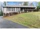 Angle shot of a one story brick home, black trim, and manicured lawn at 4540 Club Valley Ne Dr, Atlanta, GA 30319