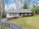 Charming one story brick home with a manicured lawn and black trim at 4540 Club Valley Ne Dr, Atlanta, GA 30319