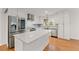 Stylish kitchen featuring stainless steel appliances, modern white cabinetry, hardwood floors, and a center island at 4540 Club Valley Ne Dr, Atlanta, GA 30319