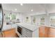Bright kitchen with stainless steel appliances, island with quartz counters, hardwood floors and large windows at 4540 Club Valley Ne Dr, Atlanta, GA 30319