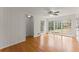 Sunlit living room boasts hardwood floors, paneled walls, and large windows overlooking the outdoors at 4540 Club Valley Ne Dr, Atlanta, GA 30319