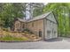Spacious home featuring brick exterior, multiple garage parking, a stone staircase, and a lush green landscape at 4540 Club Valley Ne Dr, Atlanta, GA 30319
